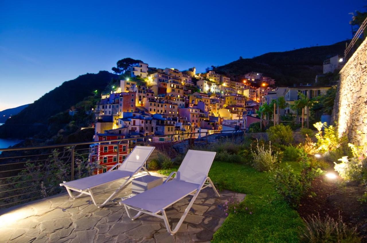 View of Riomaggiore in the background with the garden of an apartment rental in the forgeround